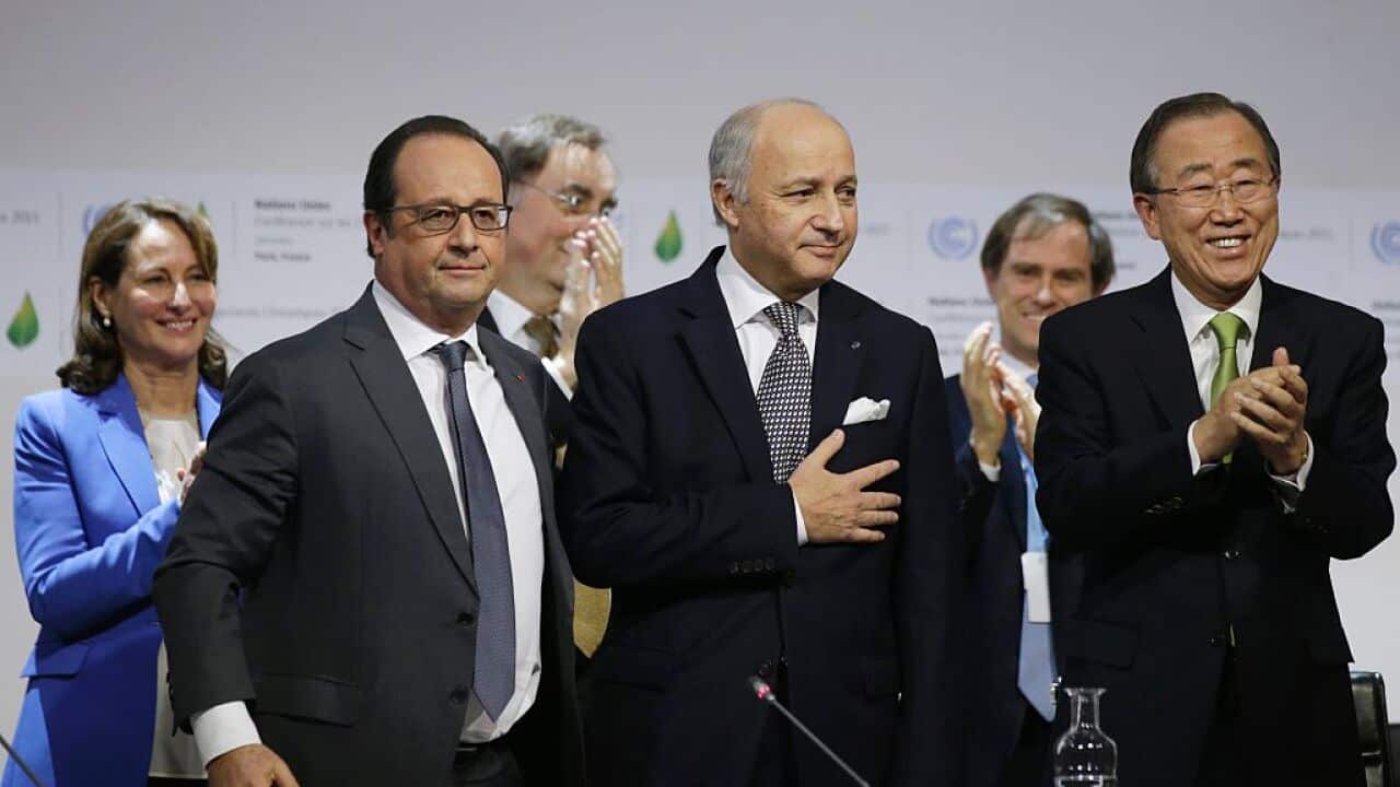 French Foreign Affairs Minister Laurent Fabius and President-designate of COP21 puts his hand over his heart after his speech as he stands with French President Francois Hollande, French Ecology Minister Segolene Royal and United Nations Secretary-General