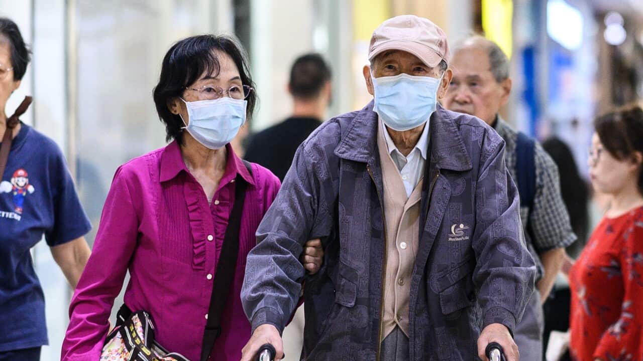 Couple wearing face masks in Sydney
