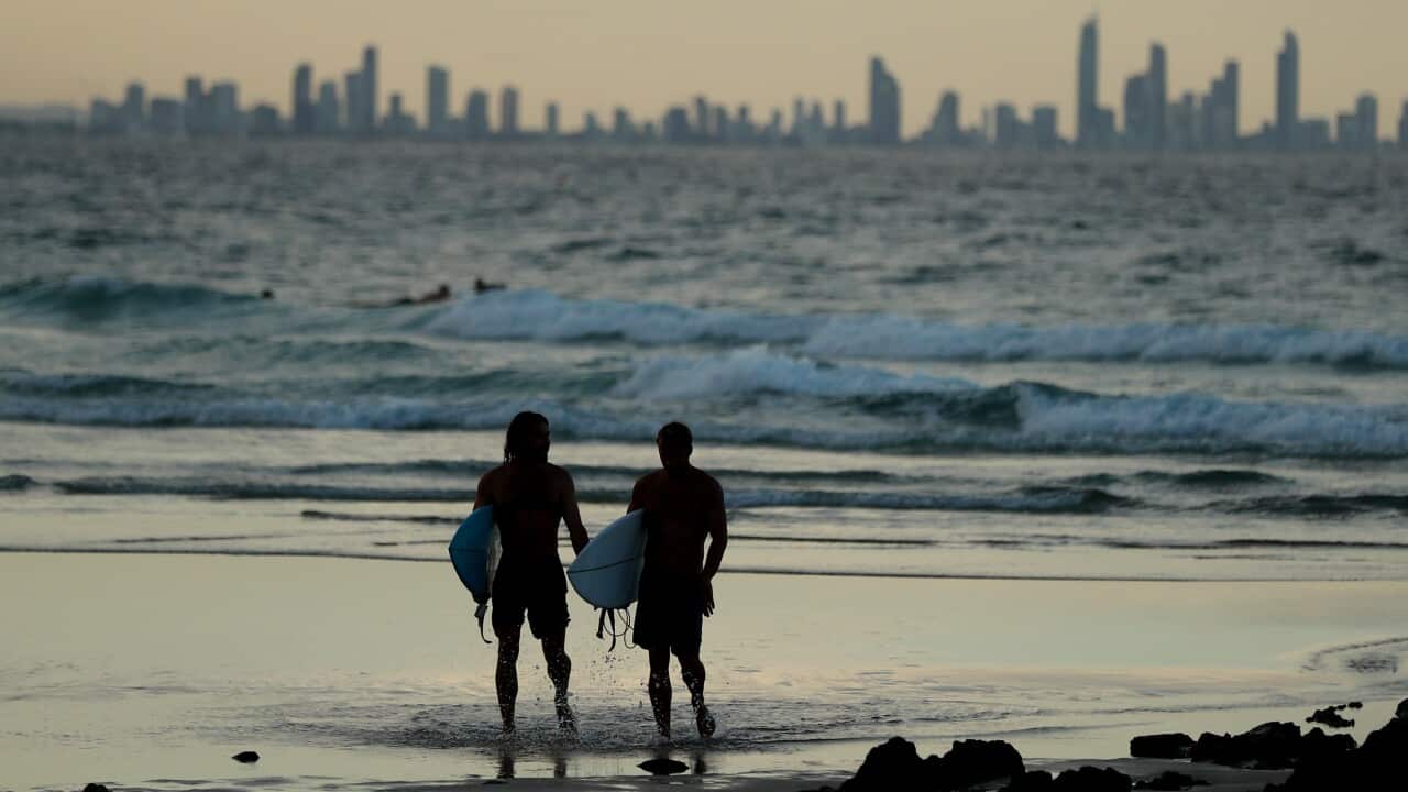 People on the beach at Snapper Rocks which is on the Queensland and New South Wales border at Coolangatta