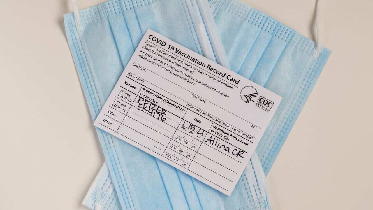 Pfizer Covid-19 vaccination record card with masks, Minnesota.
