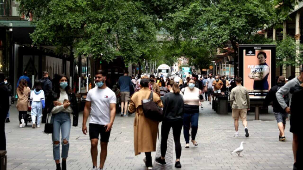Shoppers walk around Pitt Street Mall in Sydney