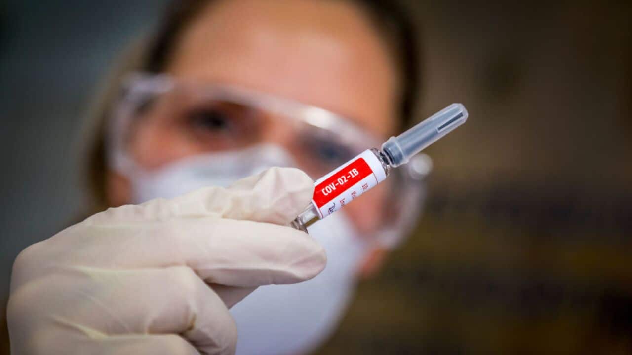 A nurse shows a COVID-19 vaccine.