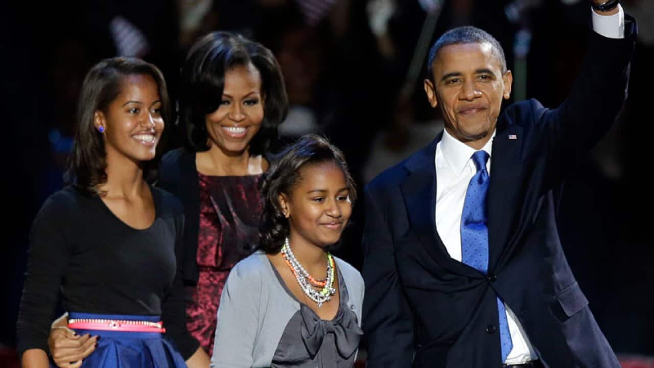 President Barack Obama with first lady Michelle Obama and daughters Malia and Sasha at his election night party in Chicago. President Obama defeated Republican challenger former Massachusetts Gov. Mitt Romney. (AAP)