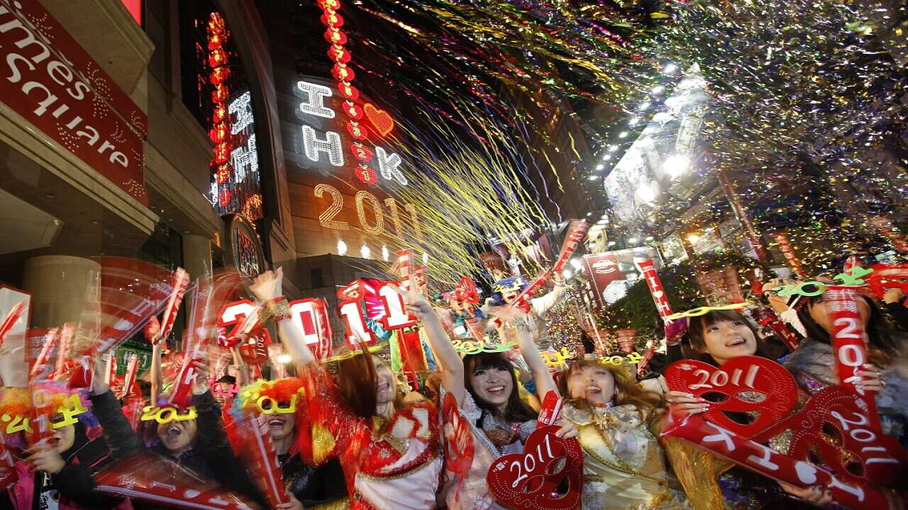 Revellers wave during the New Year's Eve celebrations in Hong Kong's Times Square, Saturday Jan. 1, 2011. (AP Photo/Vincent Yu)