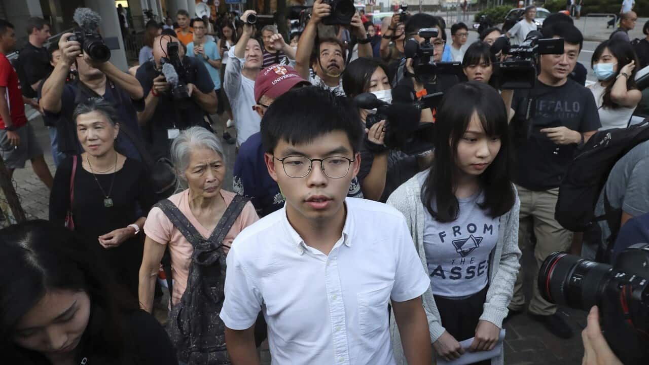 Pro-democracy activists Joshua Wong and Agnes Chow leave court last month.