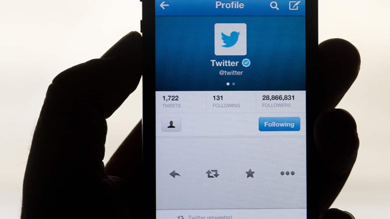 Social networking site Twitter displayed on a hand held mobile phone