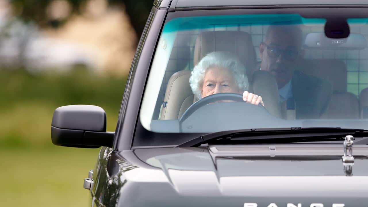 An older lady with white hair drives a Range Rover.