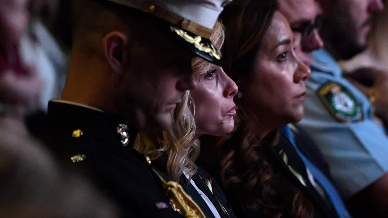 Widow Noreen Hudson (centre), wife of deceased Coulson Aviation US firefighter Paul Hudson, is seen during a Bushfire State Memorial at Qudos Bank Arena in Sydney, Sunday, February 23, 2020. (AAP Image/Bianca De Marchi) NO ARCHIVING