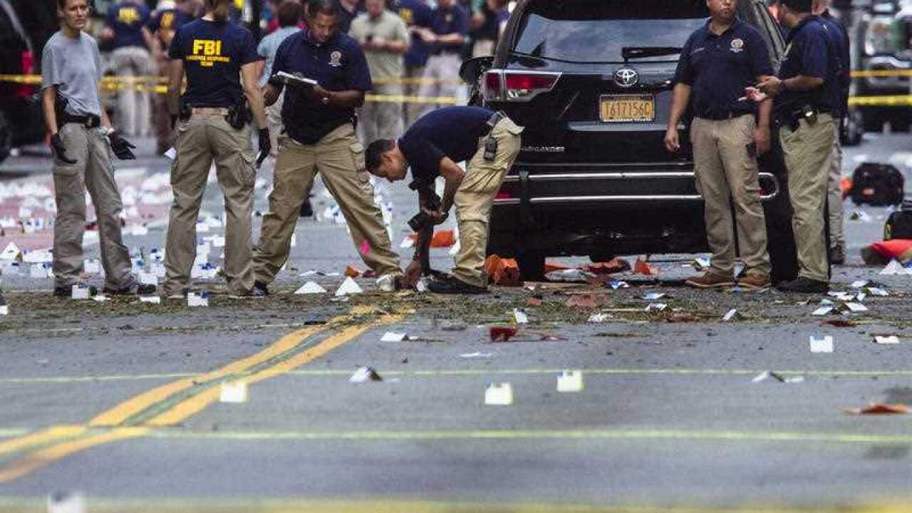 Members of the Federal Bureau of Investigation (FBI) carry on investigations at the scene of Saturday's explosion on Manhattan