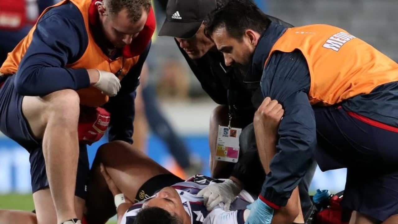 Jordan Uelese of the Rebels is injured during the Round 16.