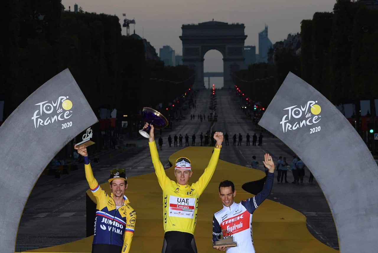 Tour de France winner Tadej Pogacar, second placed Primoz Roglic of Slovenia, and third placed Richie Porte of Australia, celebrate on the podium.