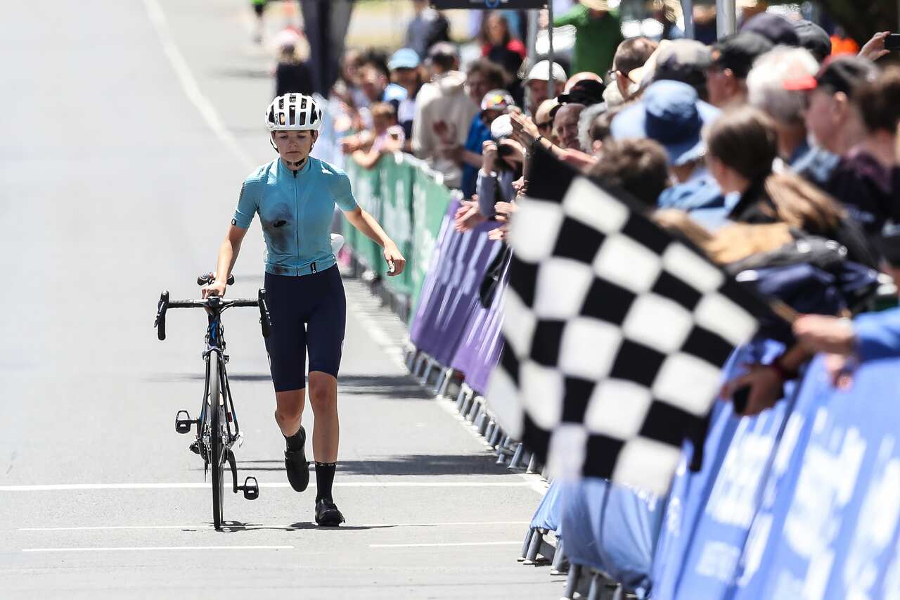 Picture of the Gold Coast’s Francesa Sewell walking her bike across the line after losing her footing in the two-up sprint against Neve Bradbury who was later DQ'd (Con Chronis)