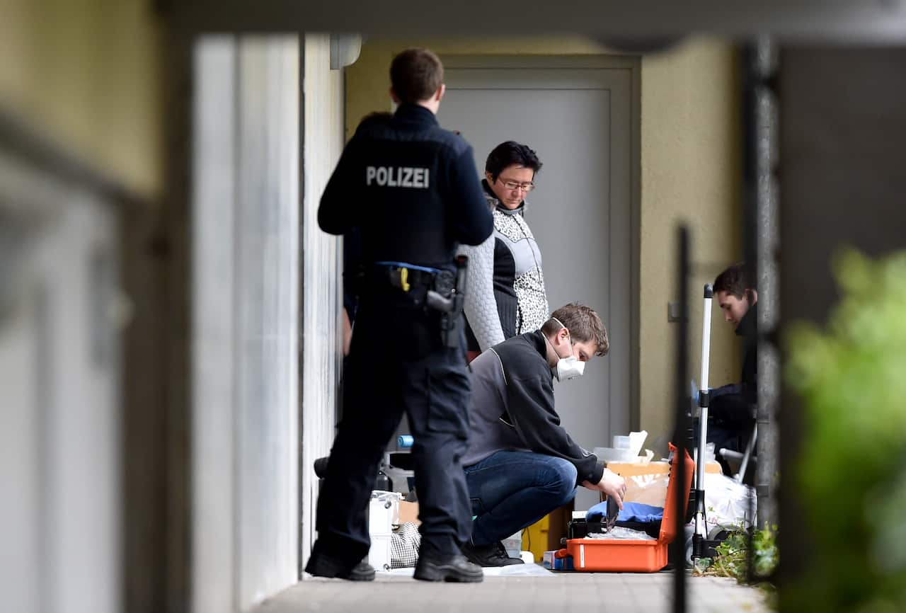 Police experts secure items on the grounds of an apartment complex in Oberursel on 30 April 2015 where they arrested a man and woman early that morning (Getty)