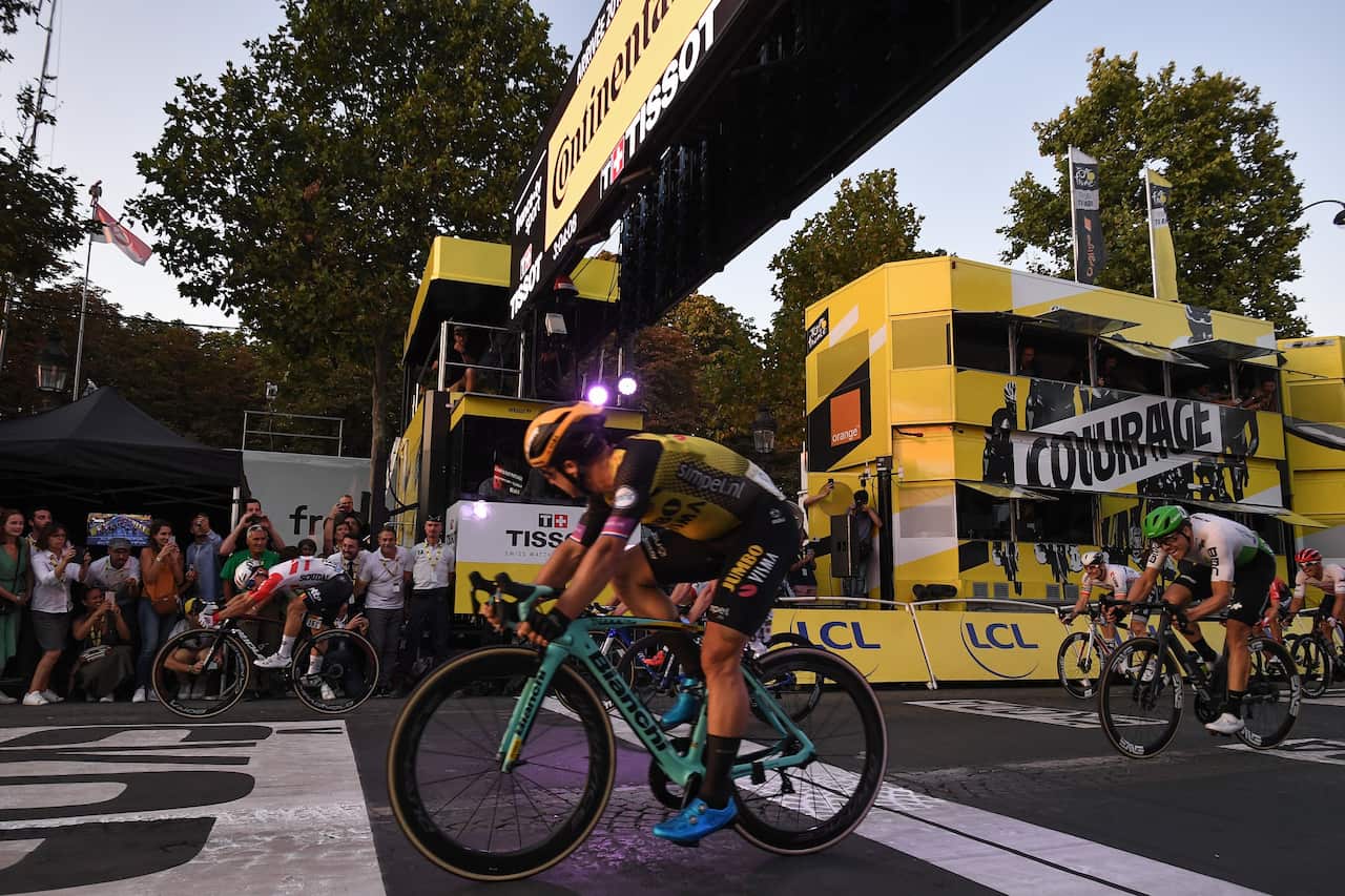 Dylan Groenewegen looks over at Caleb Ewan winning convincingly on the Champs-Élysées