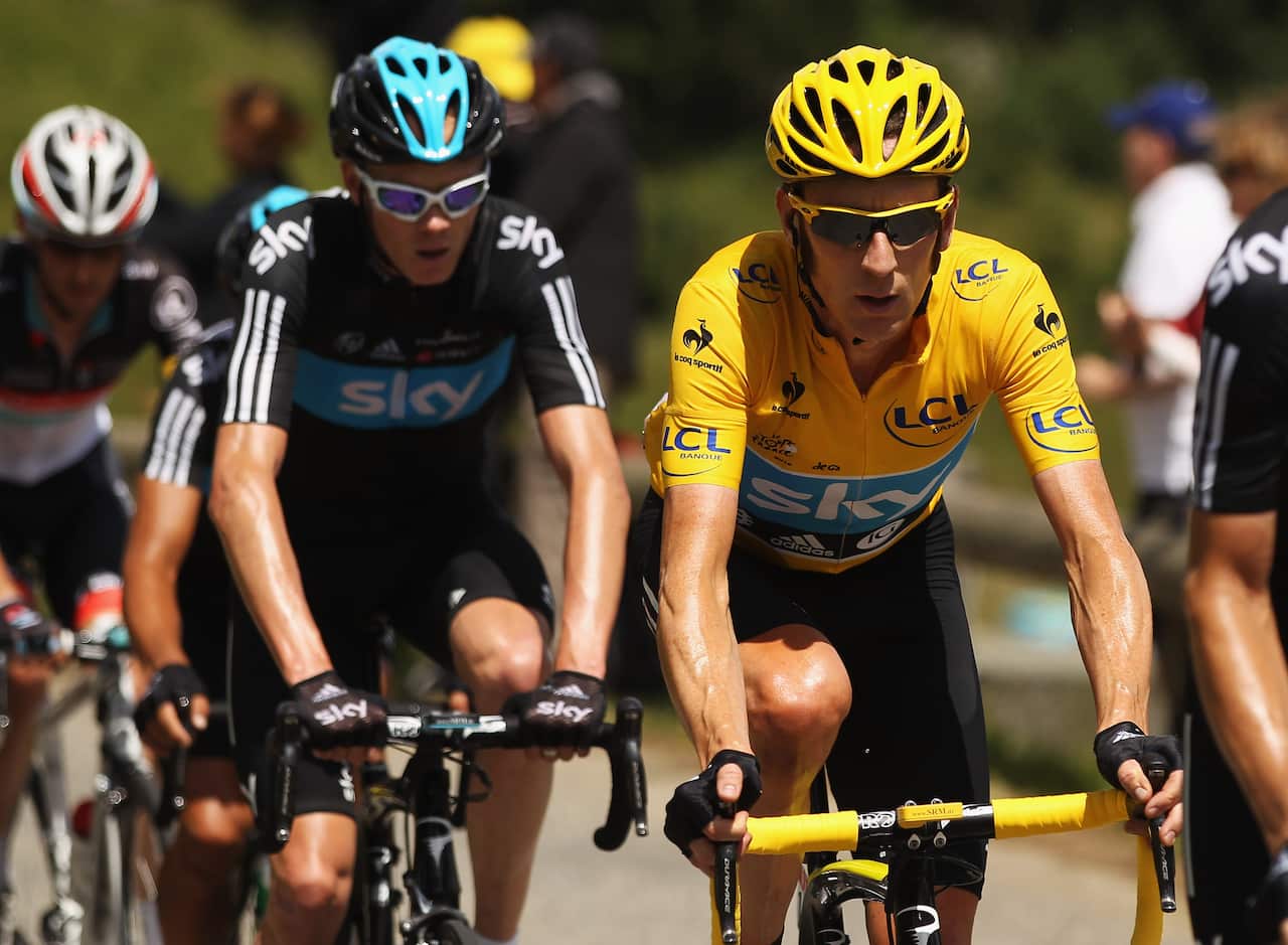 That was then... Chris Froome (L) rides behind race leader Bradley Wiggins on Stage 11 of the 2012 Tour de France.