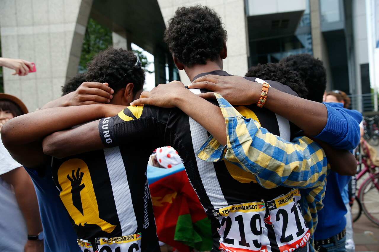 Embraced... Merhawi Kudus and Daniel Teklehaimanot find plenty of support at the Tour de France.