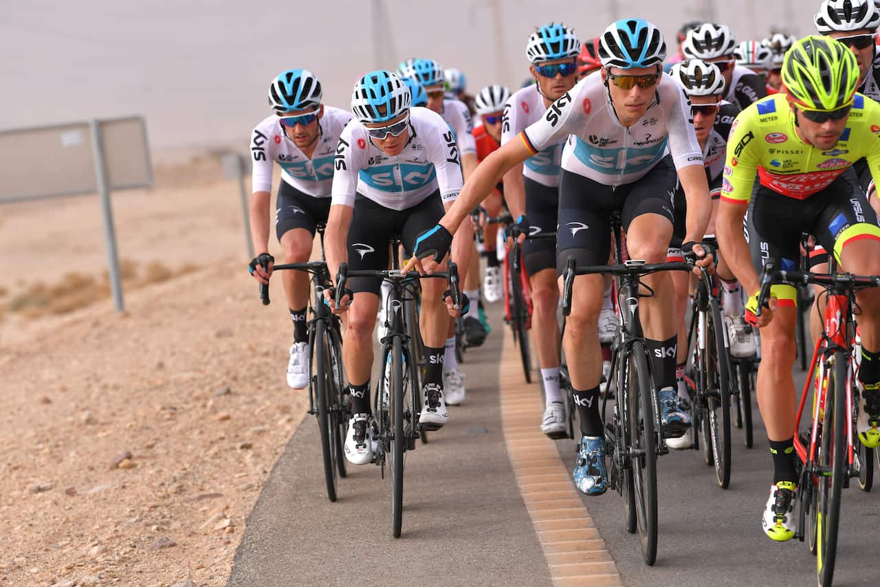 Keeping his powder dry... Chris Froome cosseted by his team-mates en route to Eilat.