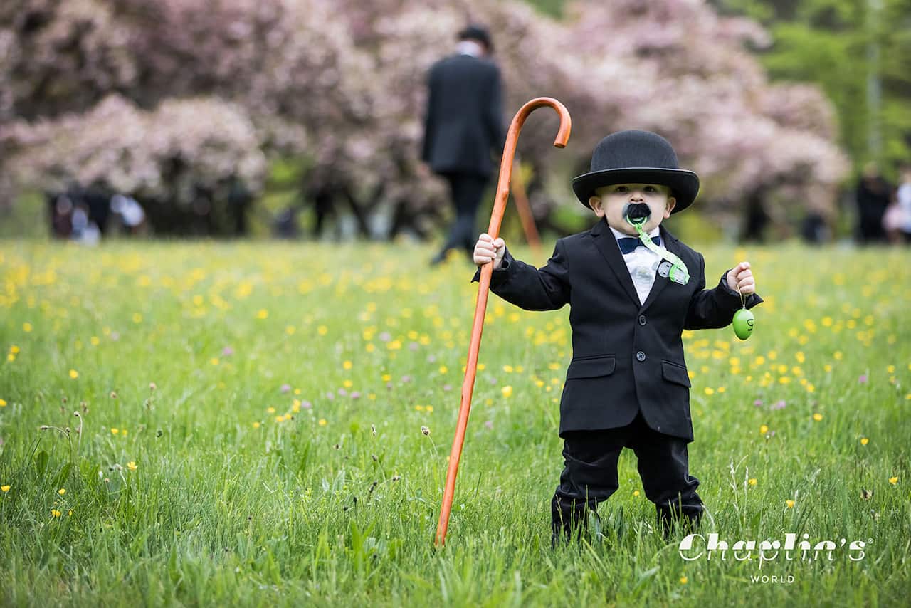 A young boy dressed as Charlie Chaplin