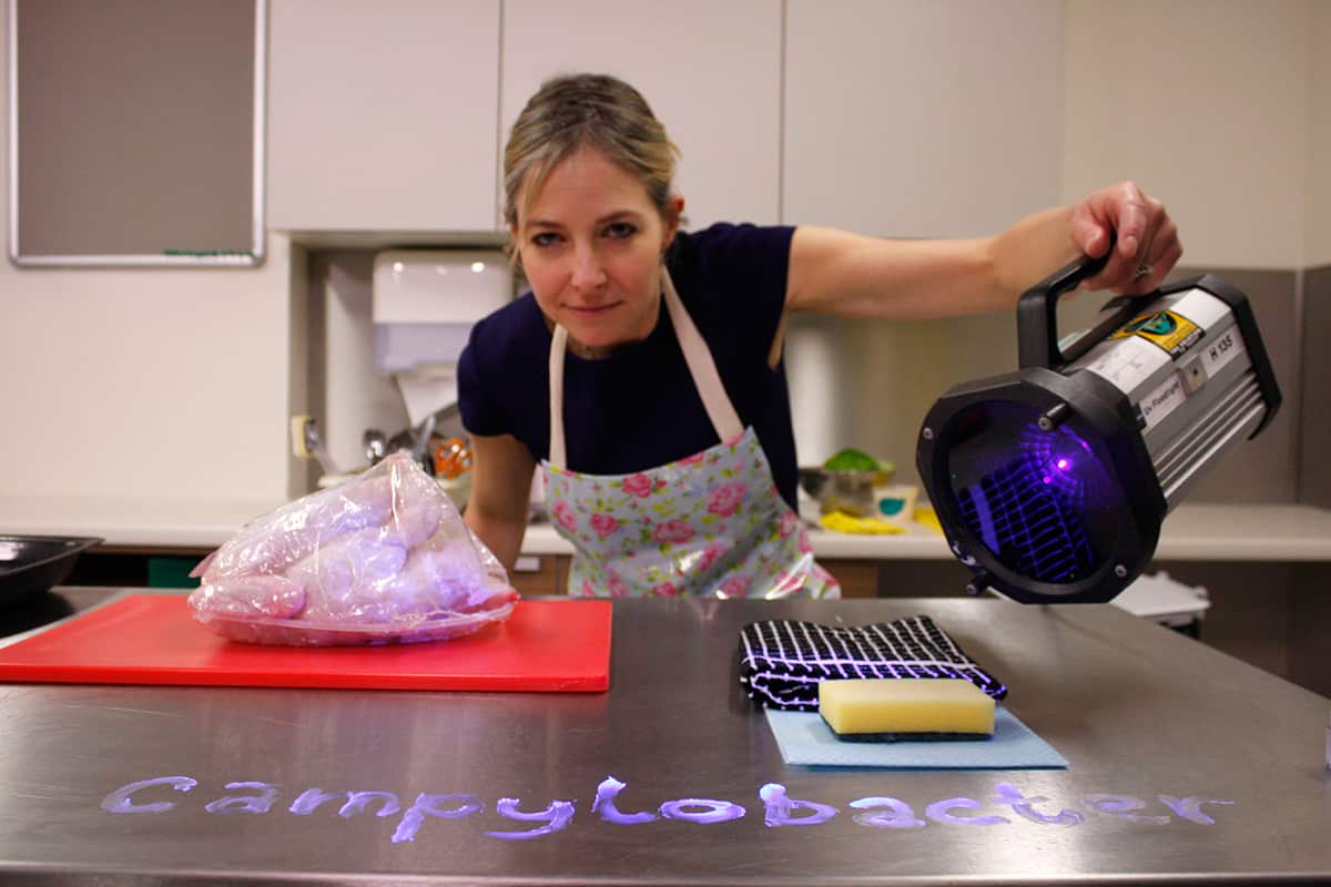  Professor Alice Roberts showing the right way to handle raw chicken in Food Detectives 