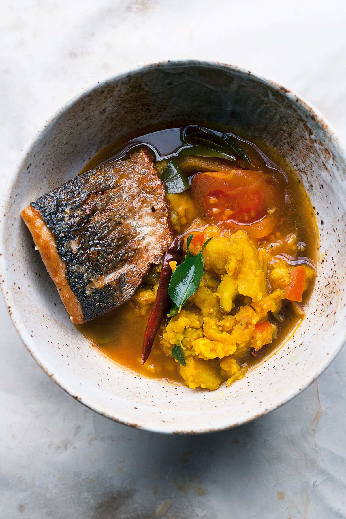 Sea bass and turmeric potatoes in rasam broth