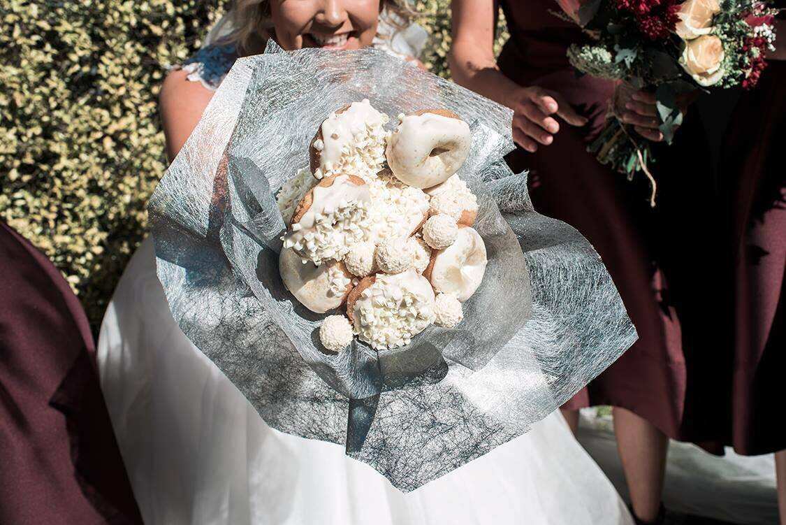 Bride Paige walked down the aisle holding a bouquet made of doughnuts.