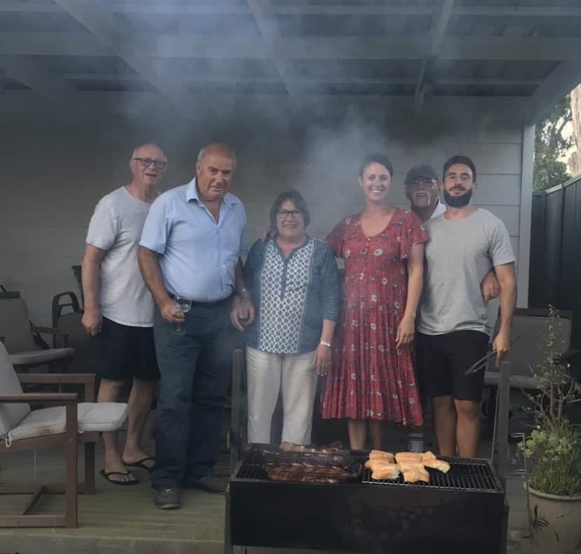 Natalie Tarleton and her family holding an authentic asado barbecue. 