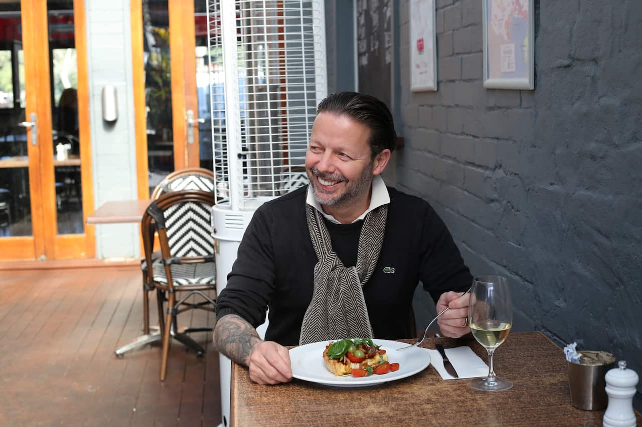 Pictured: David Bitton, owner and managing director of The Bitton Group, eating a warm cheese tart at Bitton Alexandria.