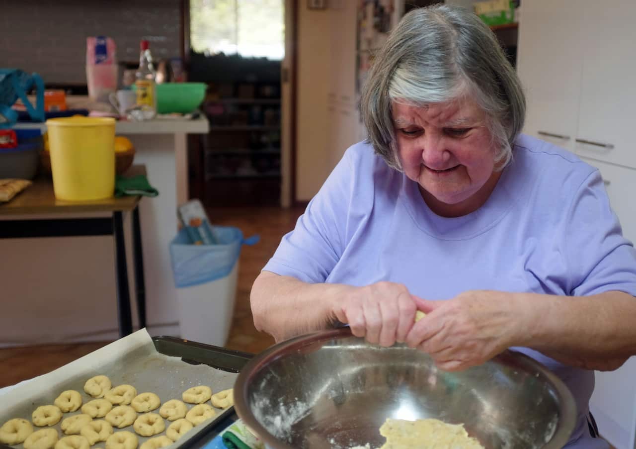 Tata Emmie rolling out rosquitos, using the extra flour hack.