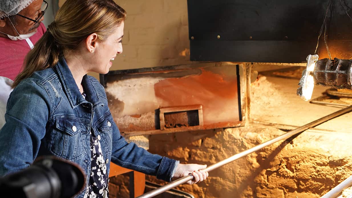 Pati Jinich puts coyotas in oven at Dona Coyo