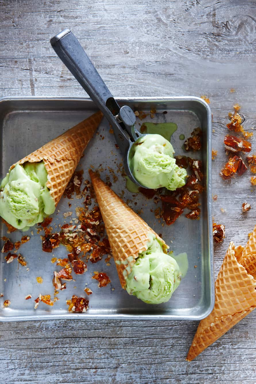 Pandan ice-cream with toffee pecans in a waffle cone