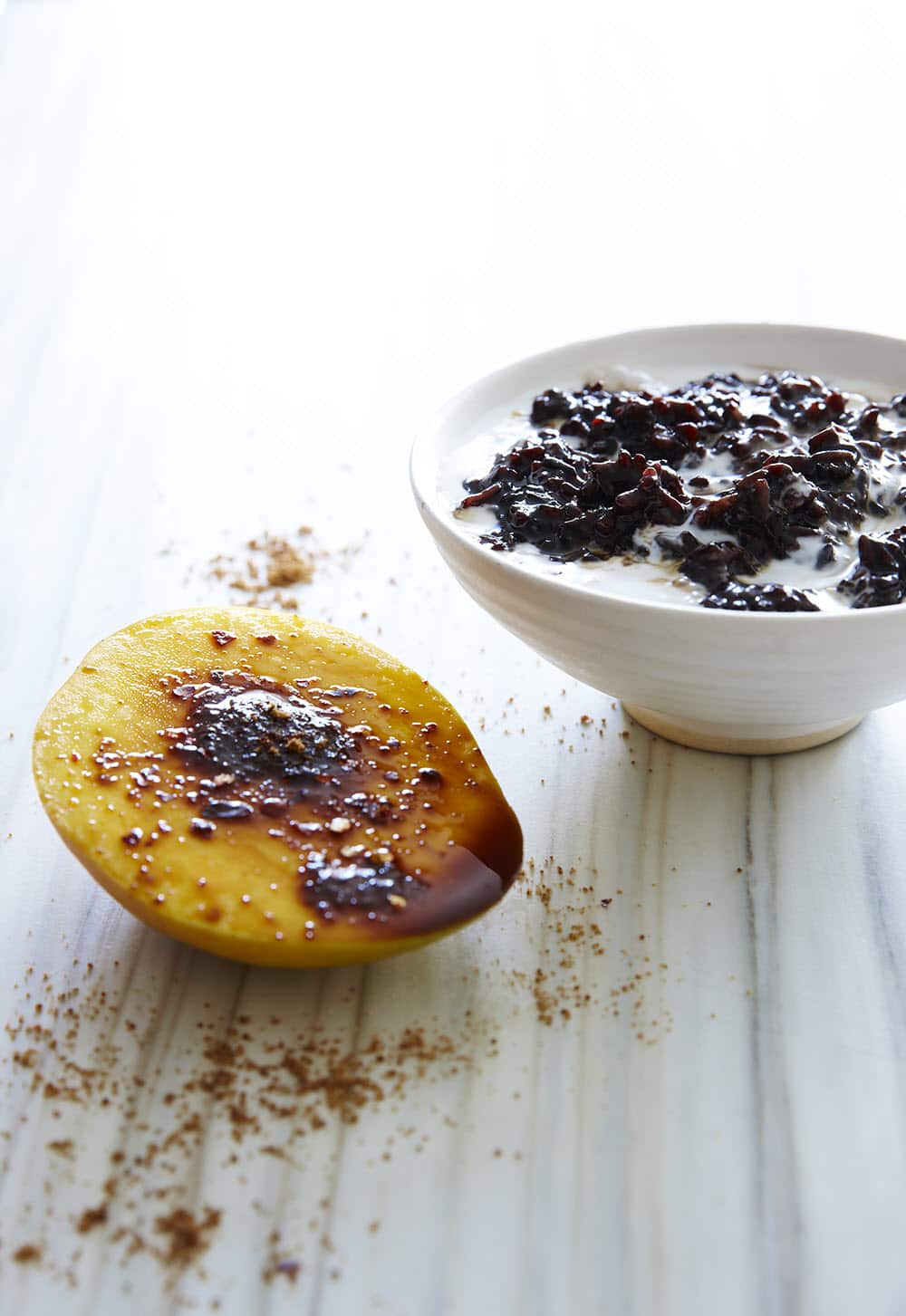 Pandan-infused black sticky rice with mango and chilli sugar