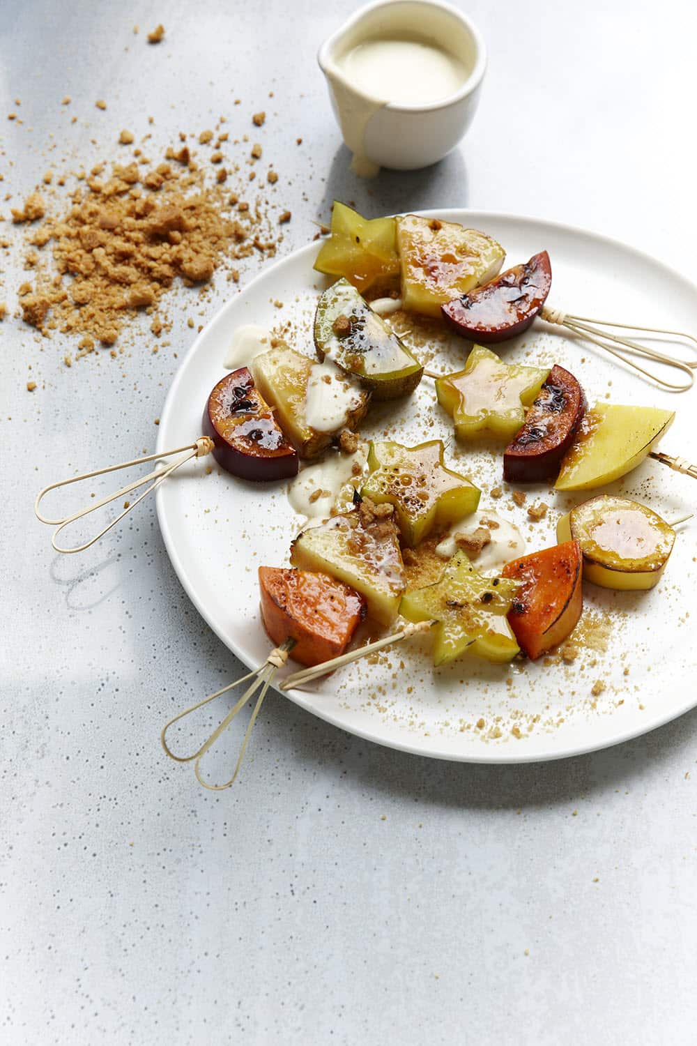 Bruleed fruit skewers with gingersnap crumb and coconut cream