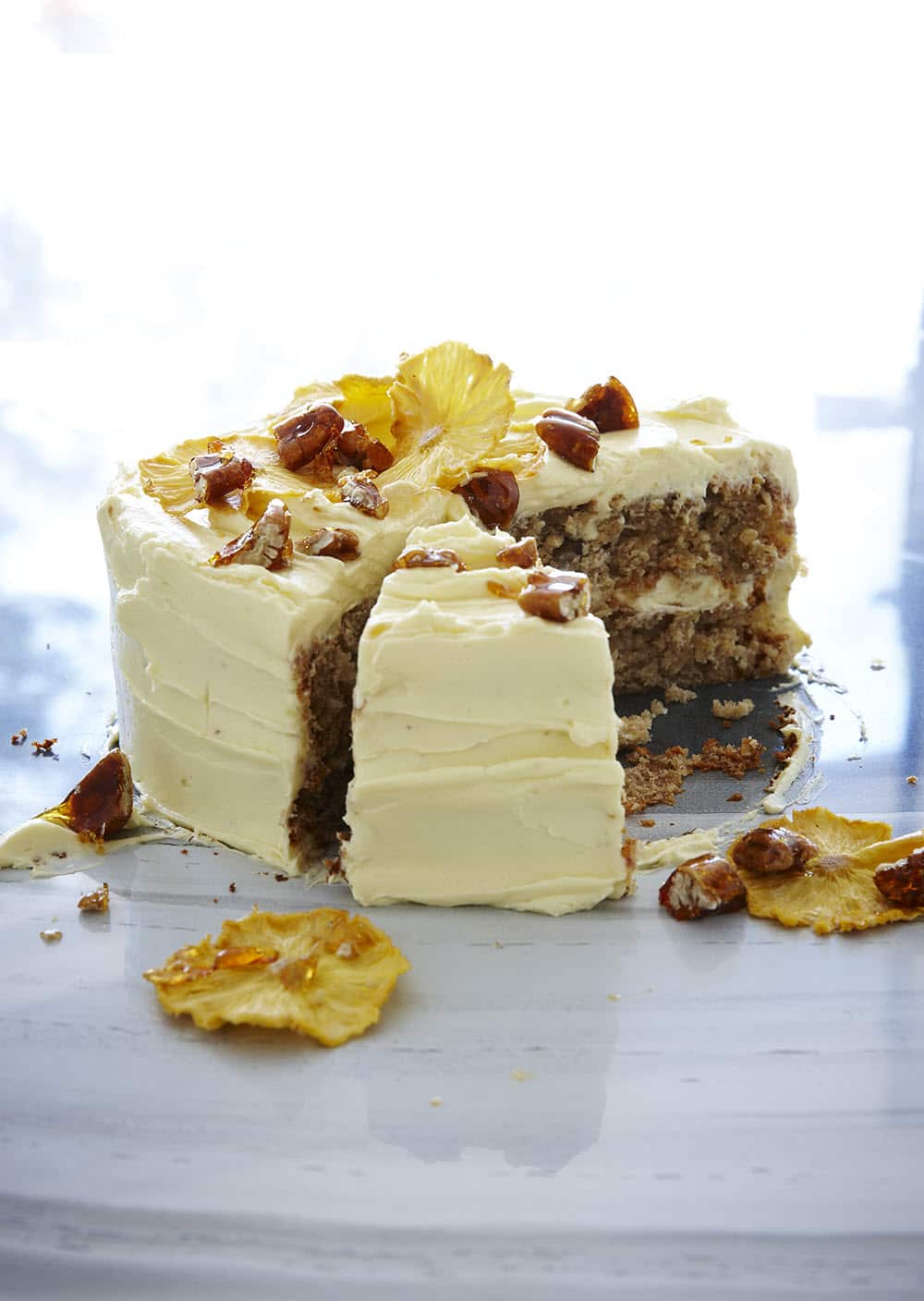 Hummingbird cake with cream cheese frosting, dried pineapple and toffee pecans