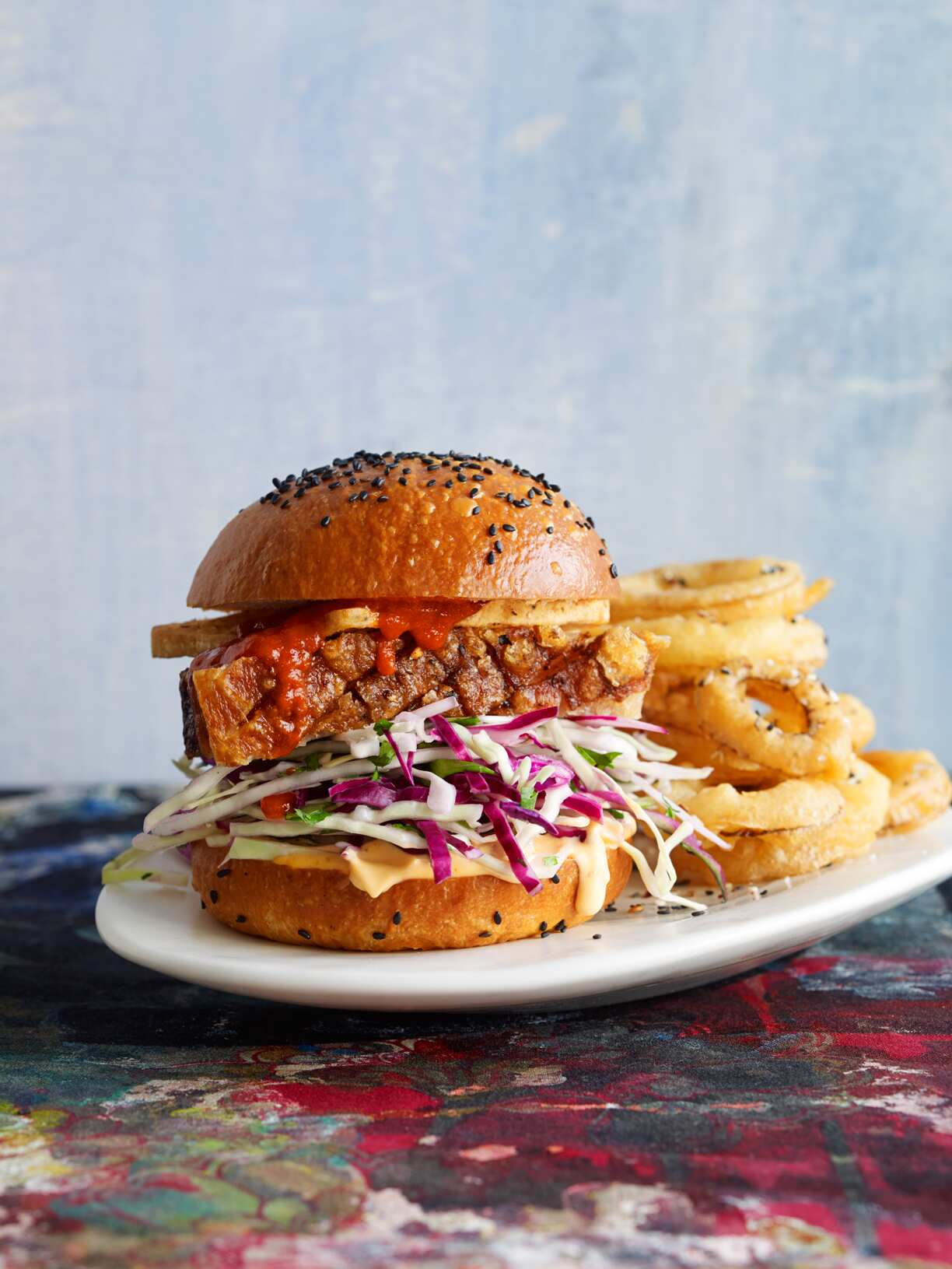 Pork belly, tofu and Sriracha slaw burgers with Sichuan onion rings