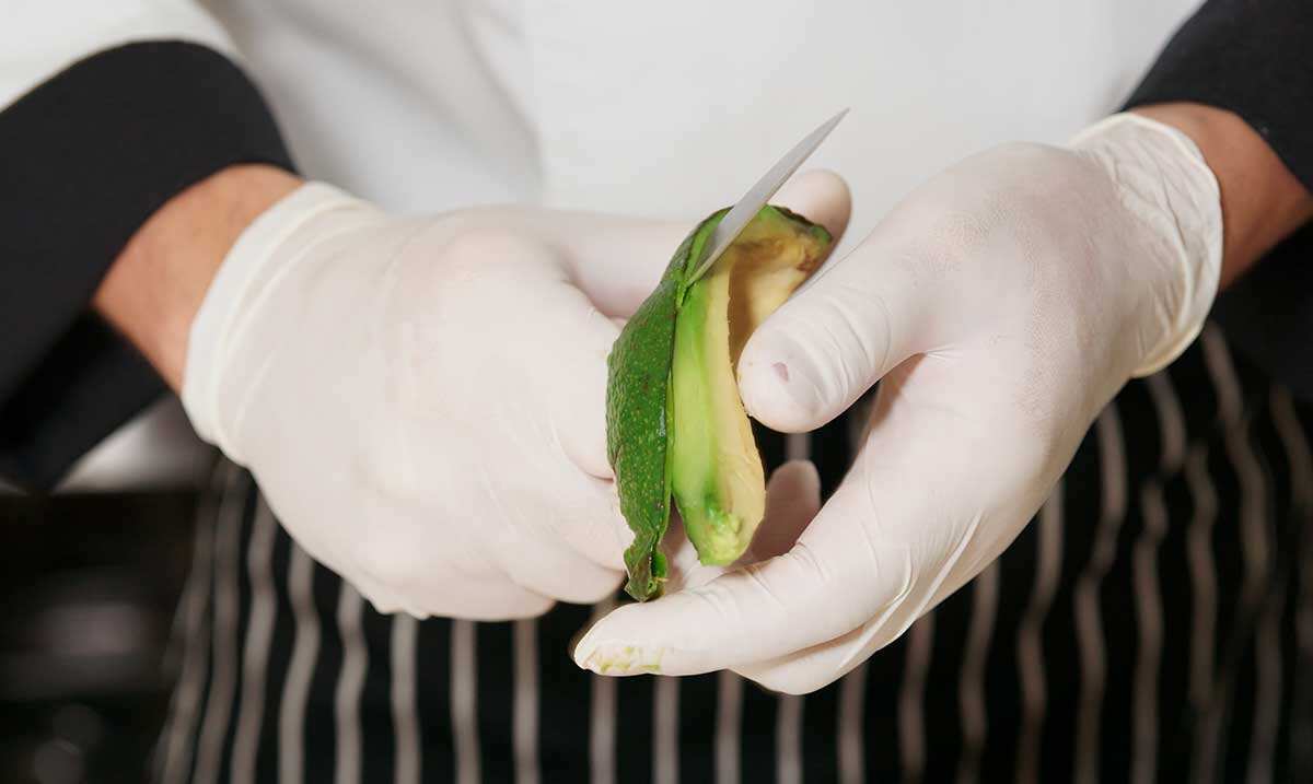Chef peeling avocado 