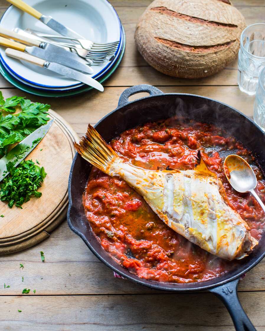 Baked leatherjacket with tomatoes and capers