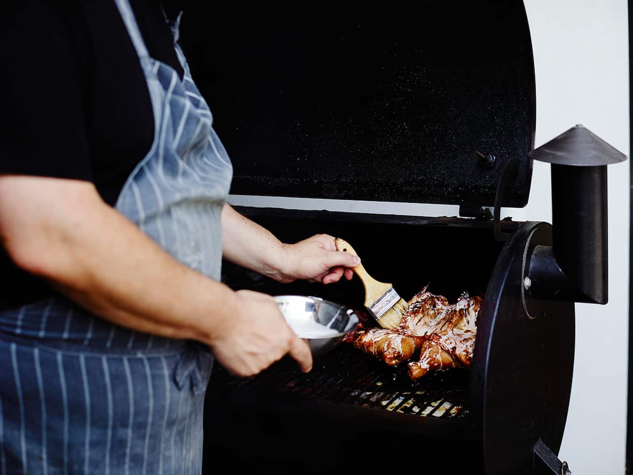Basting BBQ chicken with white sauce