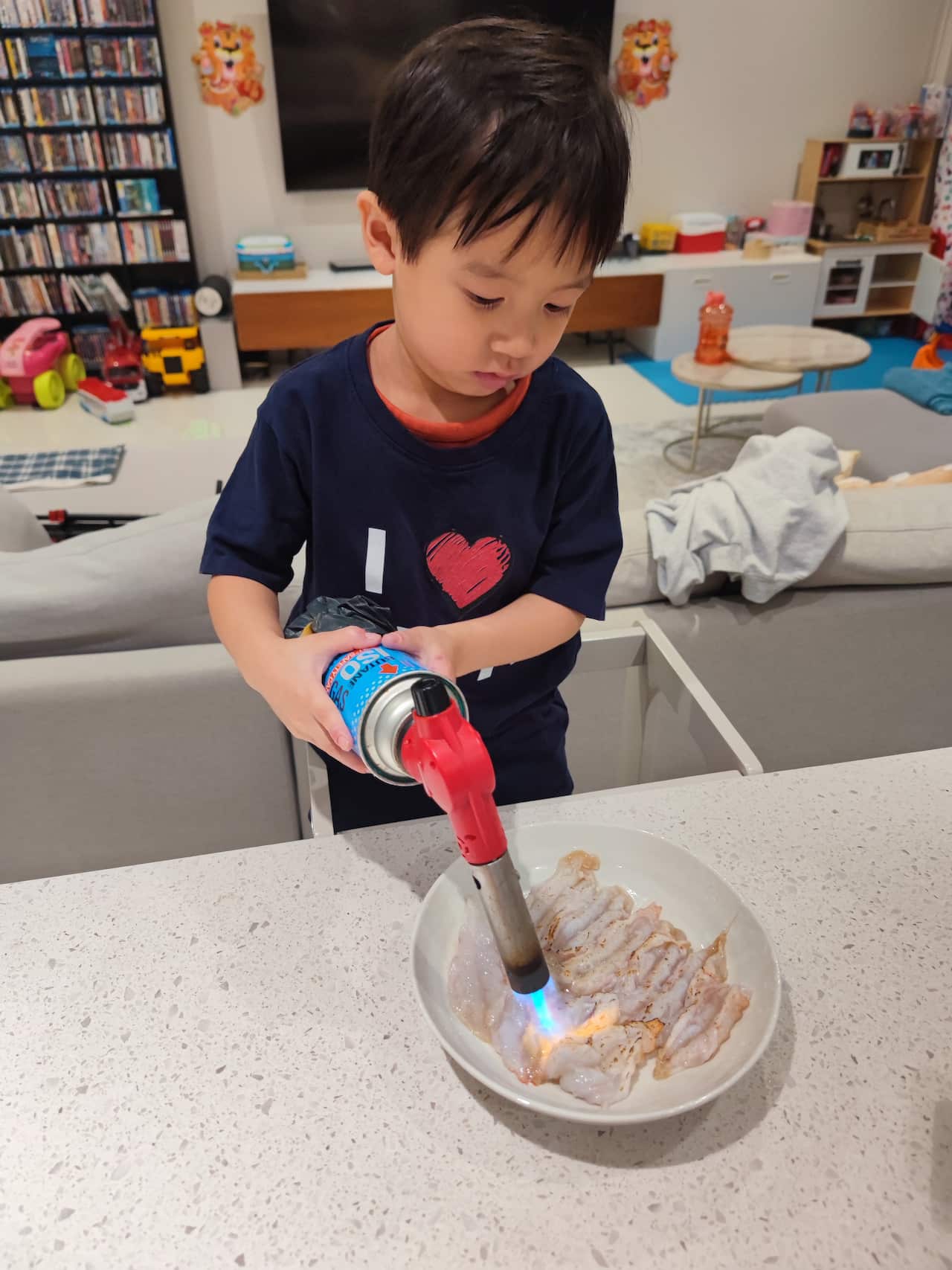 Junda Khoo's child uses a blowtorch