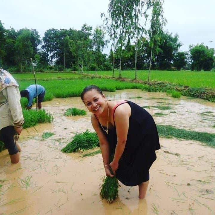 Boo helping her family at her father's rice paddies.