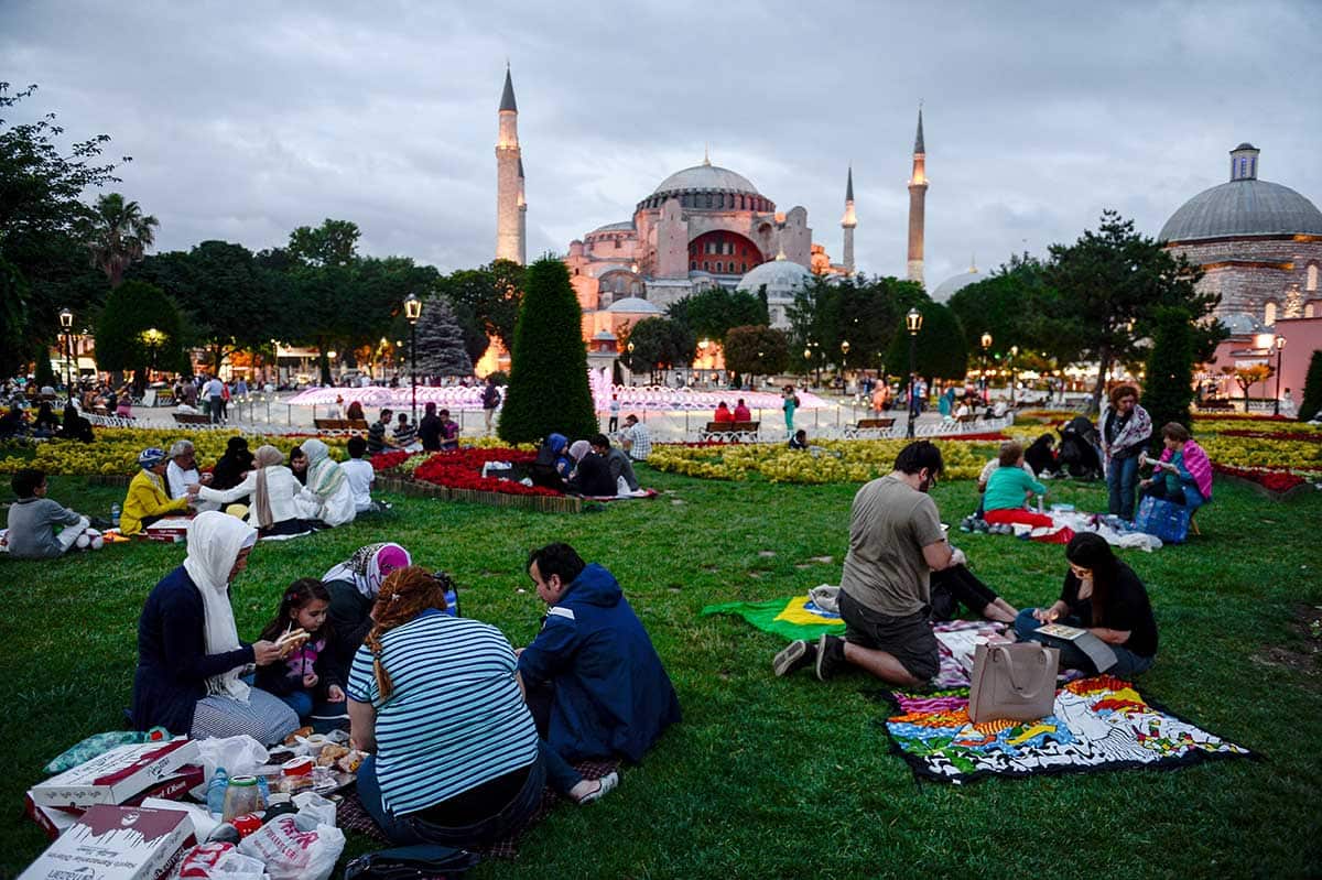 Muslims gather to break their fast in Istanbul, outside Sultanahmet Mosque