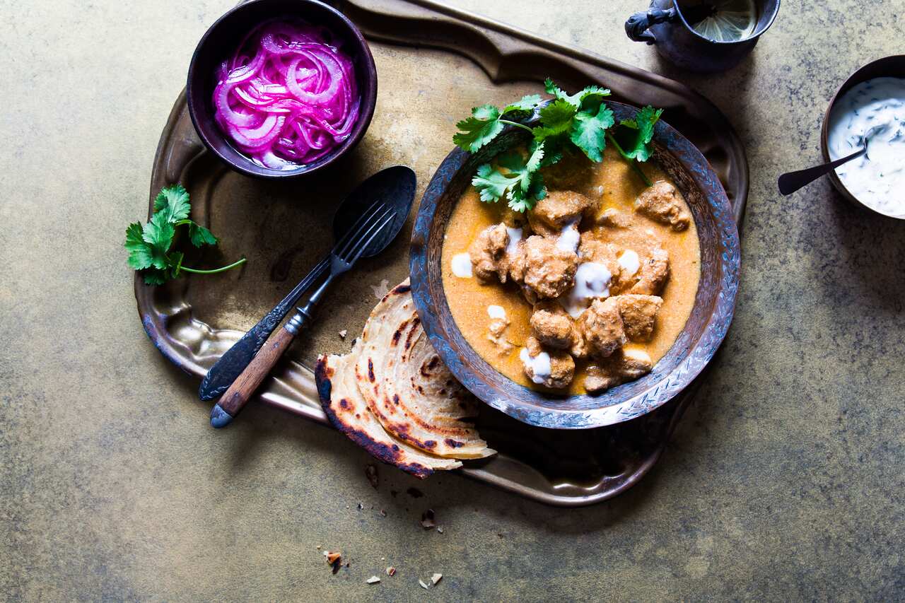 Butter chicken with mint yoghurt and pickled onions