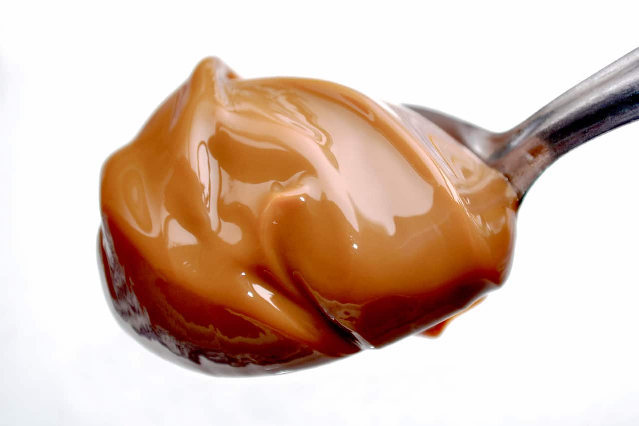 A Spoon with Milk Caramel Spread better nown as Dulce de Leche.