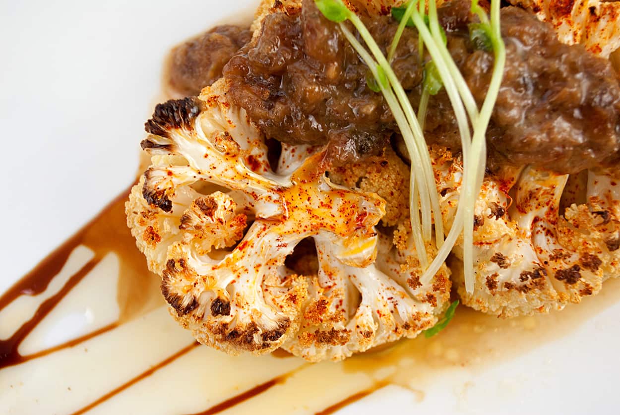 cauliflower steaks with raisin caper sauce