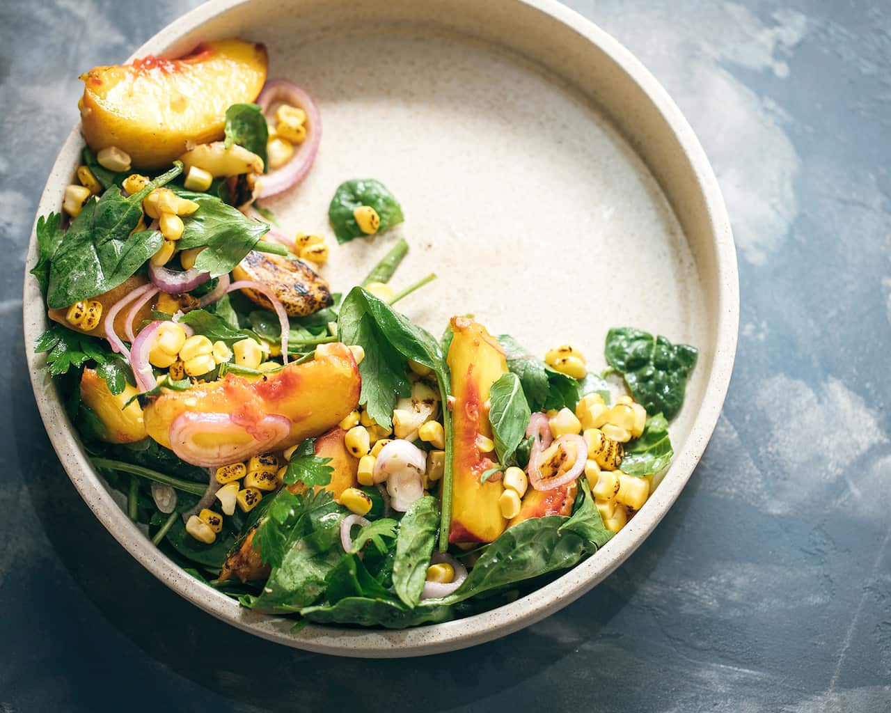 Charred peach, corn and spinach salad