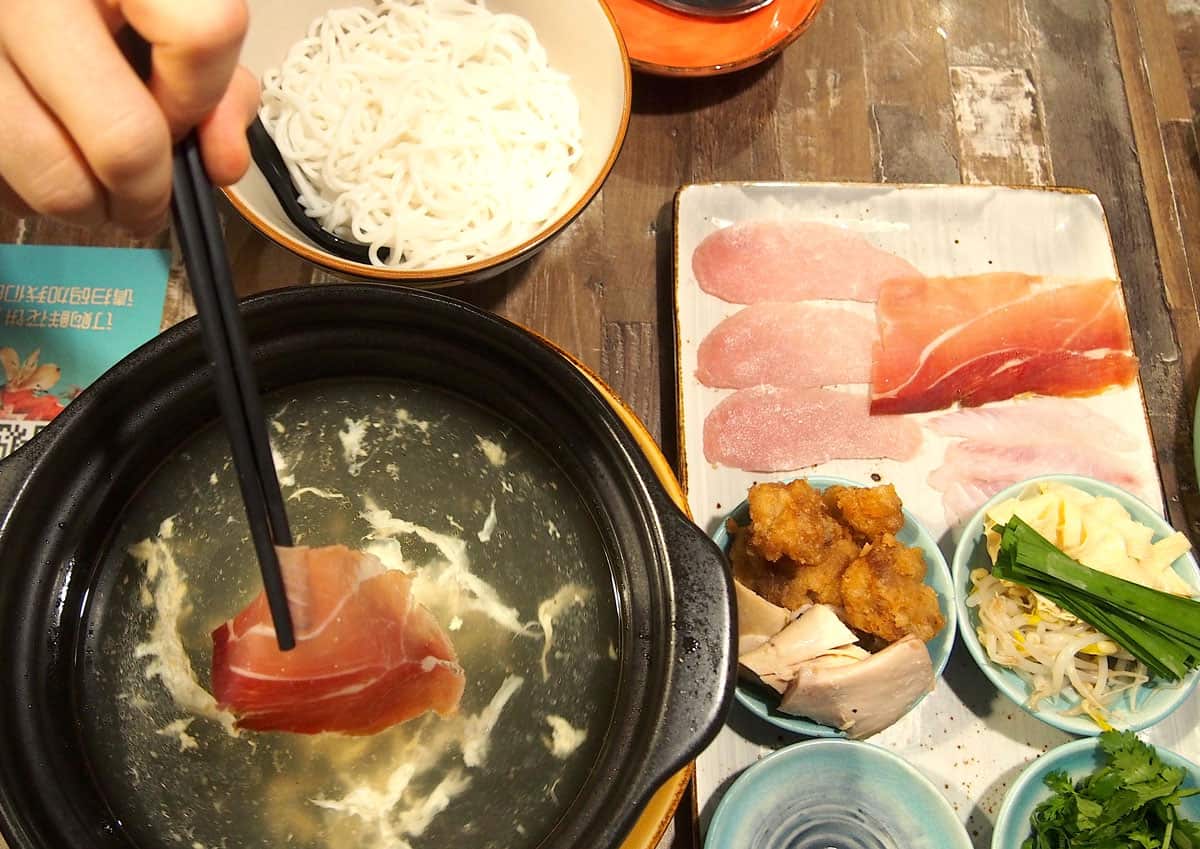 Hotpot arrives with DIY sides including prosciutto and quail eggs.