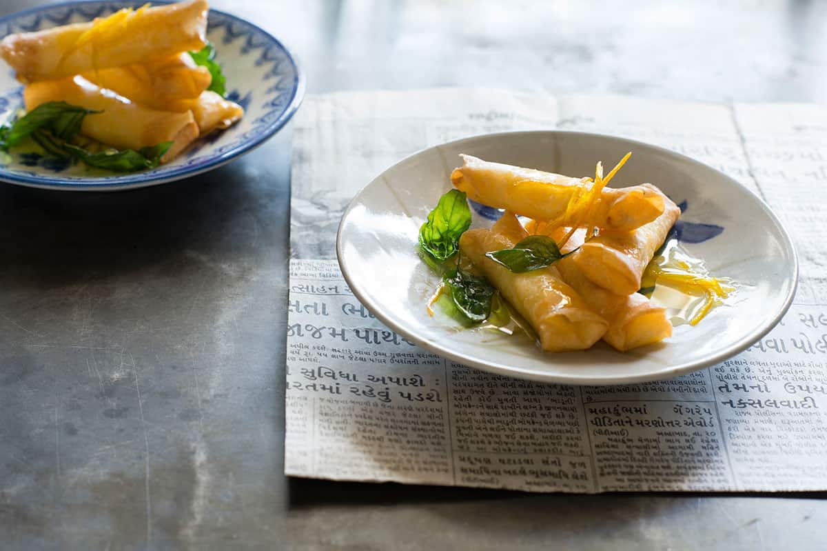 Custard spring rolls with orange syrup