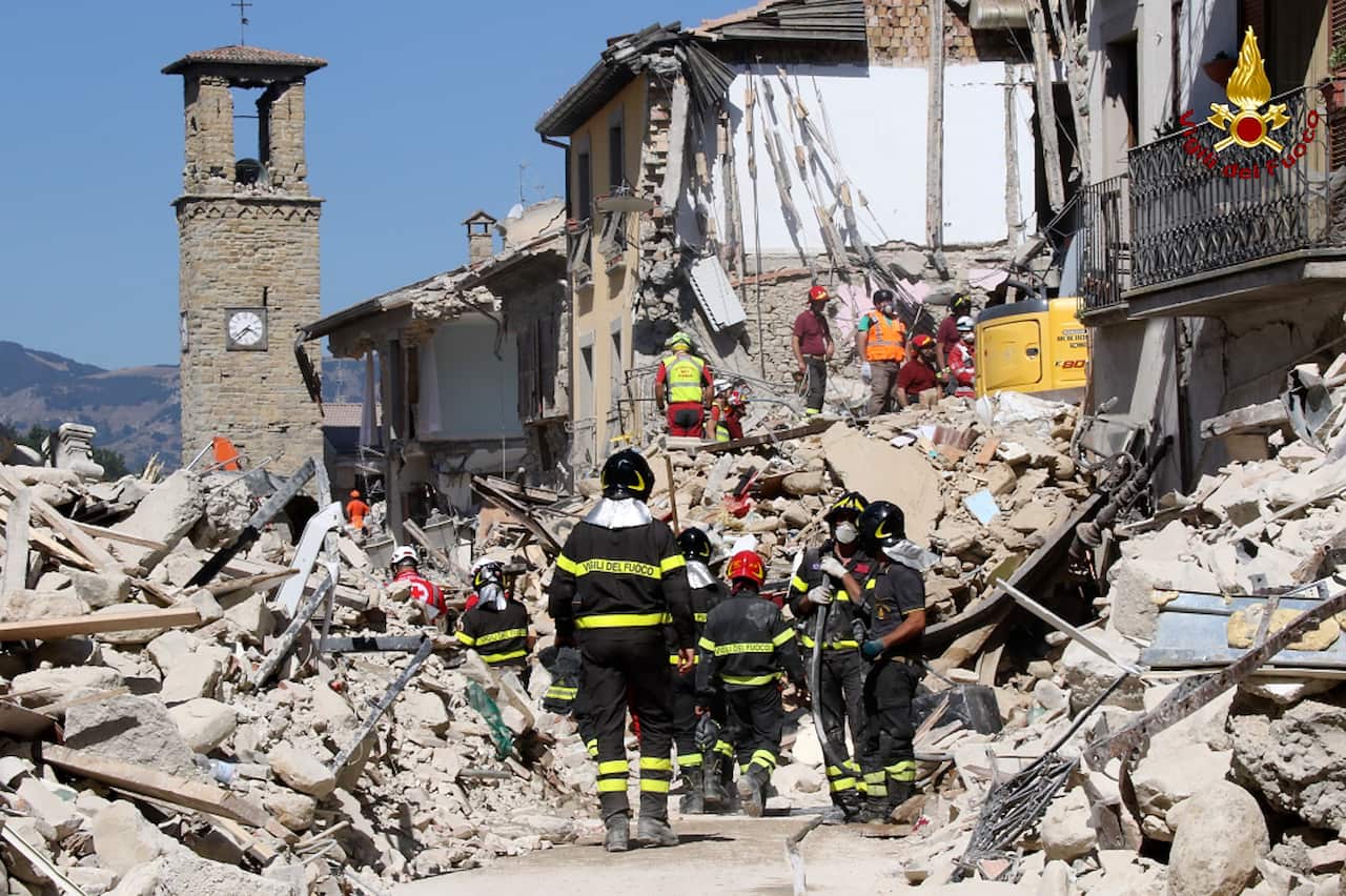 Rescuers work amid collapsed building in Amatrice, central Italy (AAP)