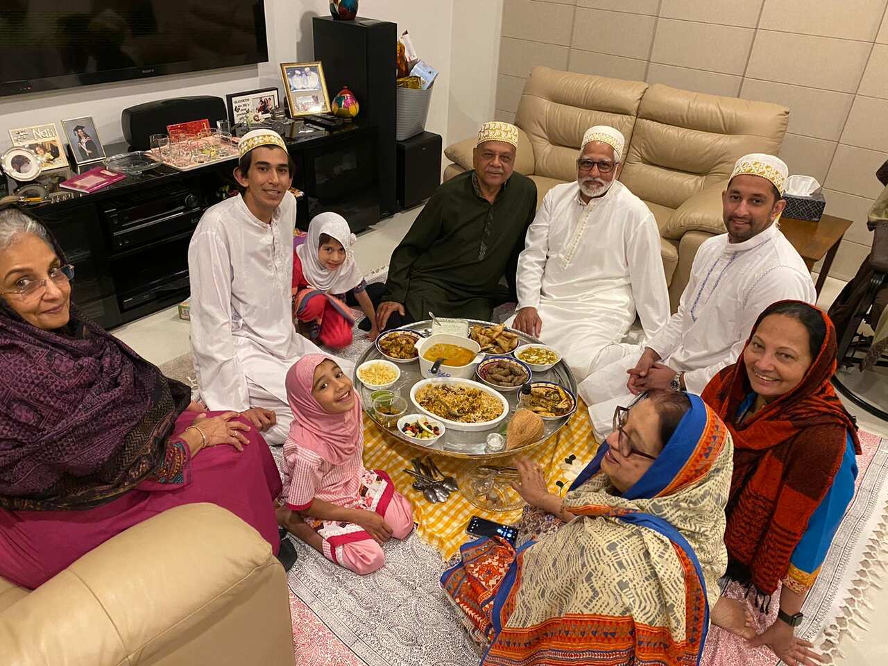 Zahra (furthest right) enjoys a traditional meal with her family.