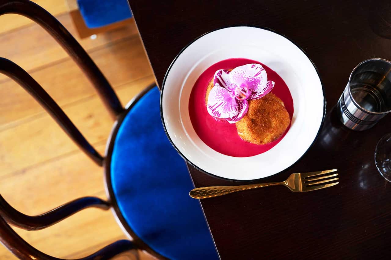 The yoghurt 'kebab' served with an edible orchid is one of the not-so-typical dishes on the menu.