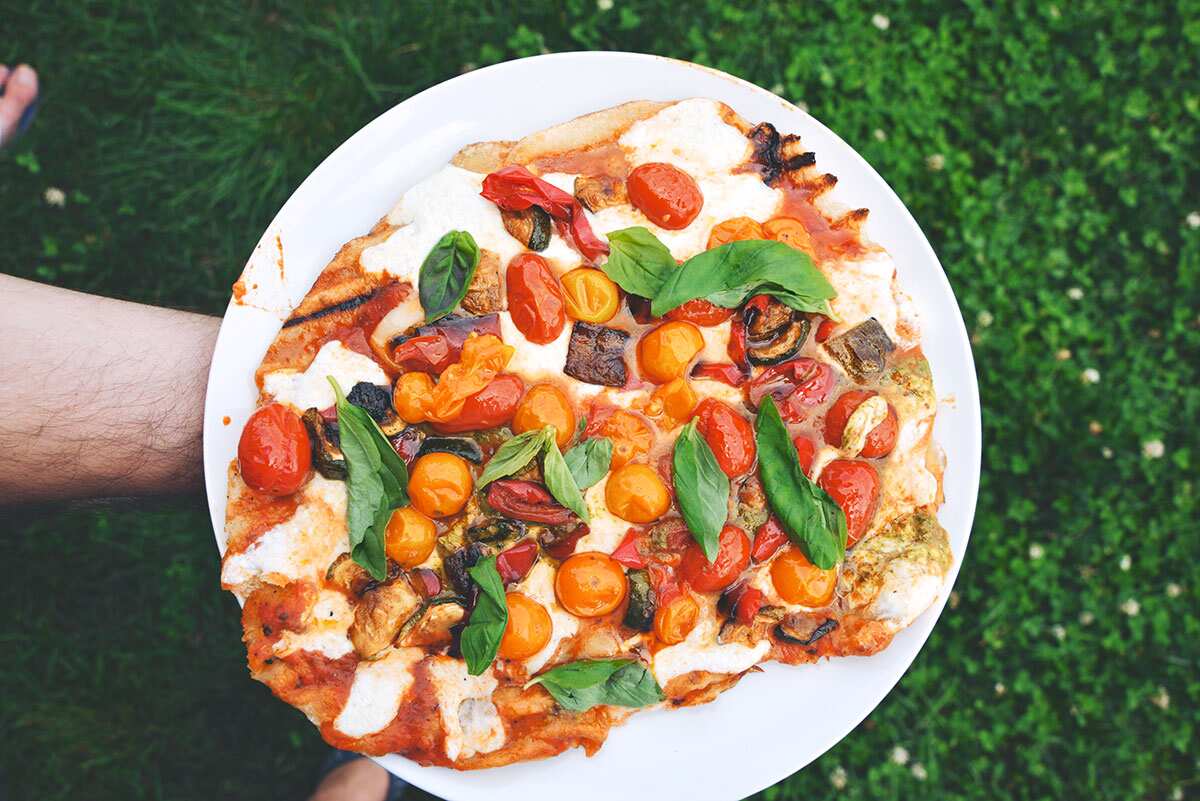 Barbecued pizza with roasted cherry tomato and garlic scape pesto
